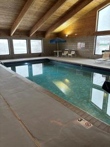 a large swimming pool in a building at AmericInn by Wyndham Webster City in Webster City