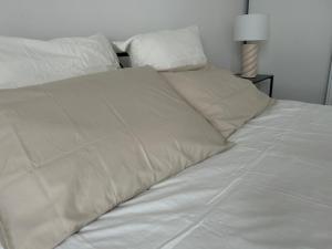 a bed with white sheets and pillows at Paris visite in Ivry-sur-Seine