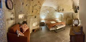a bedroom with a bed in a stone walled room at Gite 24 in Beaumont