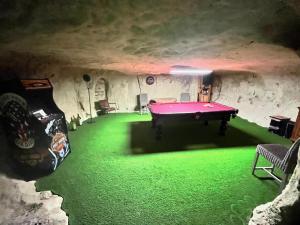 a room with a pool table in a cave at Gite 24 in Beaumont