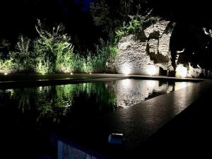 a pool of water lit up at night at Gite 24 in Beaumont