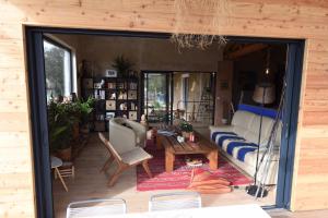 a living room with a couch and a table at SAWUBONA in Les Adrets de l'Esterel