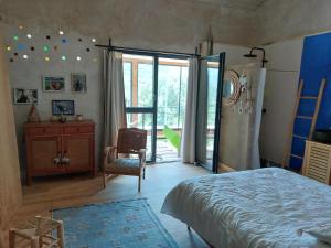 a bedroom with a bed and a sliding glass door at SAWUBONA in Les Adrets de l'Esterel +50 photos