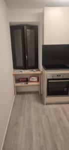 a living room with a television and a stove at J&D Comfort Apartment in Cresciano +6 photos