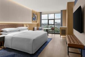 a bedroom with a large white bed and a large window at Four Points by Sheraton Xi'an Bell Tower in Xi'an +26 photos