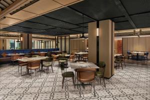 a restaurant with tables and chairs in a room at Four Points by Sheraton Xi'an Bell Tower in Xi'an