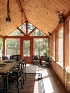 a wooden pavilion with a table and chairs at Chalet rustique, Lac paisible, Canot, Famille in La Conception