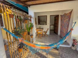 a porch with a hammock in a house at Casa do Francês in Japaratinga