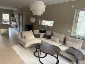 a living room with a couch and a table at Bexam Apartment in Växjö