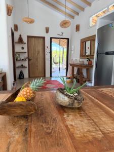 a kitchen with a wooden table with fruits on it at Samaya Corumbau in Corumbau
