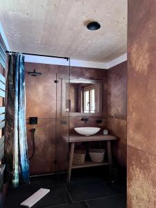 a bathroom with a sink and a shower at Chalet Hirschegg - modernes Dorfchalet mit Panorama in Leutasch +24 photos