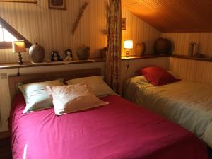 two beds sitting next to each other in a room at La boulitte in Asnois