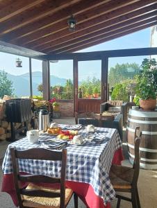 a table with a plate of food on a patio at Casa Rural ASTEI in Muxika