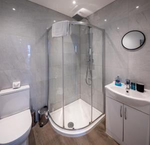 a bathroom with a shower and a toilet and a sink at Runswick Road in Bristol