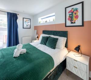 a bedroom with a large bed with a teddy bear on it at Runswick Road in Bristol