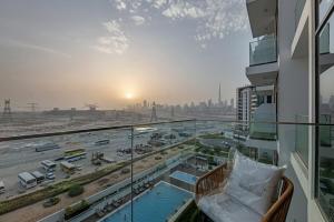 a view of a city from a balcony of a building at Waves - Modern & Vibrant Studio With Skyline View in Sabkhah