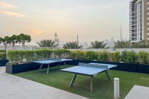 two picnic tables on the roof of a building at Waves - Modern & Vibrant Studio With Skyline View in Sabkhah +25 photos