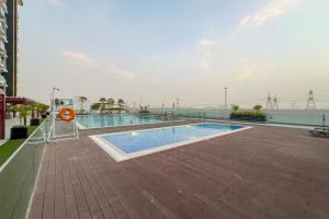 a swimming pool on the roof of a building at Waves - Modern & Vibrant Studio With Skyline View in Sabkhah