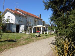 a house with a picnic table in front of it at La forge de louis in Saint-Macoux