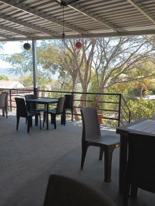 a patio with a table and chairs and a fence at Cabañas La China in El Congo