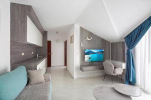 a living room with a couch and a tv at Hotel Tommy in Budva
