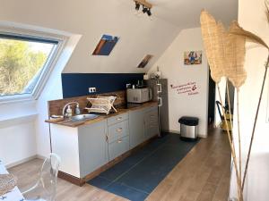 a kitchen with a sink and a counter top at Rose et violette in Brélès