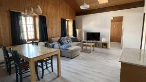 a living room with a table and a couch at Tgesa communala Mon in Mons