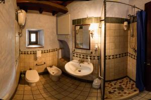 a bathroom with a sink and a toilet and a shower at Albergo Diffuso - Rocca Calascio in Calascio