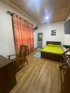 a bedroom with a bed and a table and chairs at The Ceylon Olive Resort in Katunayaka