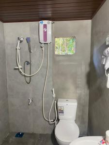 a bathroom with a toilet and a shower at The Ceylon Olive Resort in Katunayaka