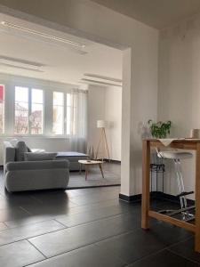 a living room with a couch and a table at Appartement Atelier in Le Noirmont +16 photos