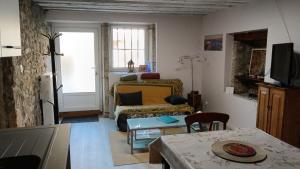 a living room with a couch and a table at La Grillère in Conliège