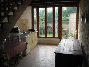 a kitchen with a sink and a stove in a room at Le grenier d'alice in Thurageau