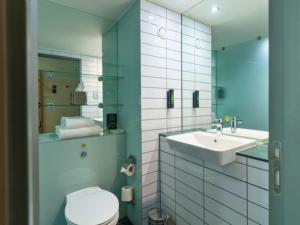 a bathroom with a sink and a toilet and a mirror at B&B HOTEL Birmingham Centre in Birmingham