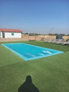a shadow of a man standing in front of a swimming pool at Cabaña en Litueche - Parcela in Cartagena