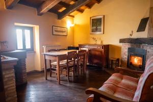 a dining room with a table and a fireplace at Albergo Diffuso - Rocca Calascio in Calascio