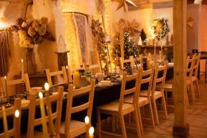a dining room with a long table with candles and chairs at Pod mazurskim niebem dom rustykalny in Piecki +77 photos