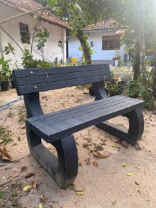 a wooden bench sitting in front of a house at The Ceylon Olive Resort in Katunayaka