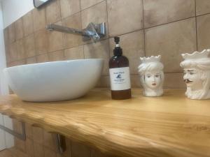 a bottle of wine sitting on a counter next to a sink at Blue Wave Apartment in Letojanni +16 photos