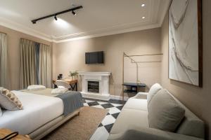 a bedroom with a bed and a fireplace at De Domínguez Hotel Boutique in Seville