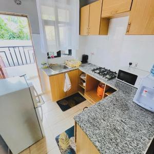 a kitchen with a sink and a counter top at Bethany Cushy Home Ltd in Kisii +3 photos