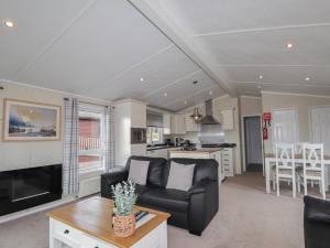 a living room with a couch and a table at Iona Lodge in Fort William