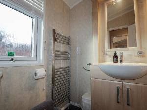 a bathroom with a sink and a mirror and a shower at Iona Lodge in Fort William +16 photos