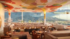 a restaurant with a view of the mountains at Hotel Londres in Caracas