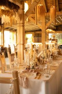 a long table with glasses and candles on it at pod mazurskim niebem loft in Piecki +63 photos