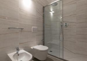 a bathroom with a shower and a toilet and a sink at Open Space - Garden & Jacuzzi in Milan +14 photos