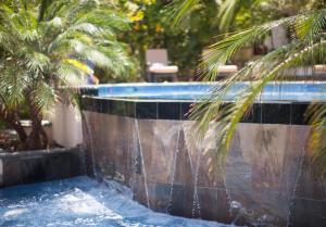 a swimming pool with a fountain in a resort at Ka'ana Resort & Spa in San Ignacio