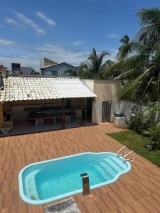 a swimming pool in the yard of a house at Casa de Praia 6 quartos e 4 suítes! in Valença