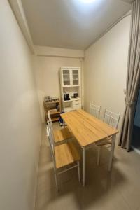 a dining room with a wooden table and chairs at Family Hostel in Chiang Rai