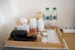 a wooden tray with bottles of water and paper towels at Family Hostel in Chiang Rai +24 photos